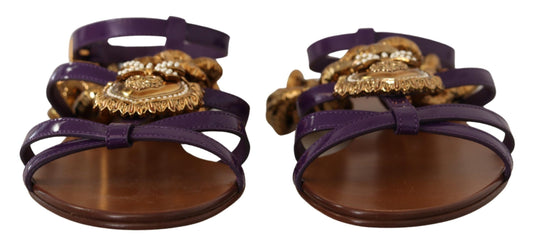 Purple patent leather flat sandals with gold-tone Devotion heart embellishments and ankle straps.