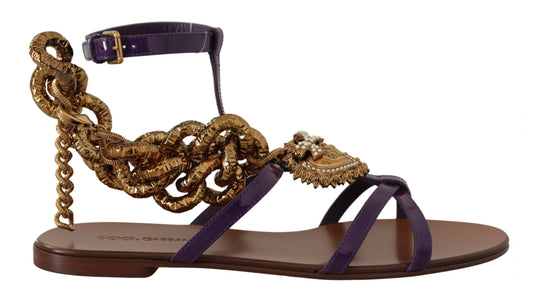 Purple patent leather flat sandal with a gold chain strap, ankle buckle, and ornamental heart emblem with pearls.