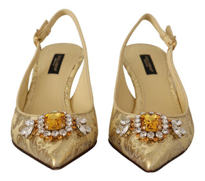 Dolce & Gabbana gold brocade slingback pumps with a pointed toe and large central crystal embellishment.