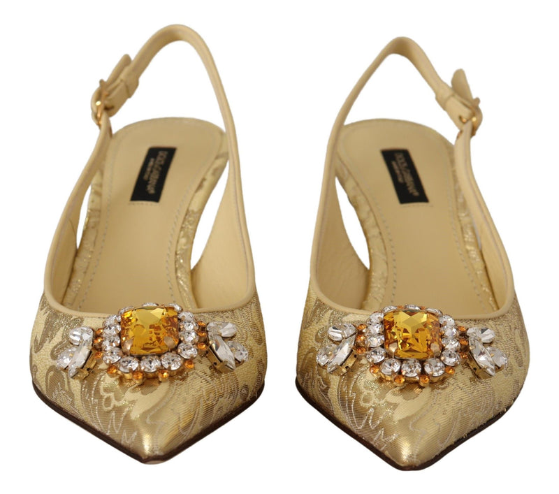 Dolce & Gabbana gold brocade slingback pumps with a pointed toe and large central crystal embellishment.