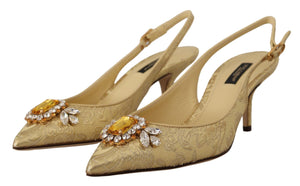 Gold brocade slingback pumps with pointed toes and large amber and clear crystal embellished buckles.