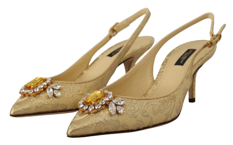 Gold brocade slingback pumps with pointed toes and large amber and clear crystal embellished buckles.