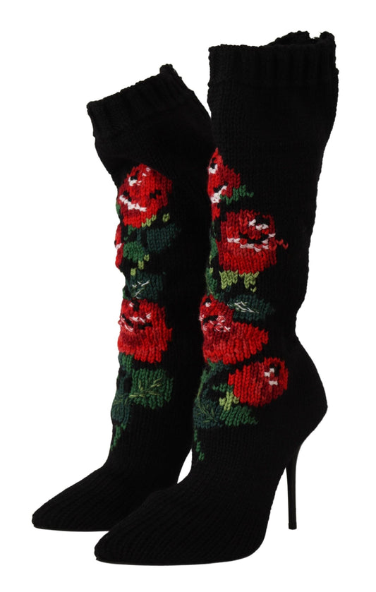 Black knit sock booties featuring red rose floral embroidery and a pointed toe with a high stiletto heel.