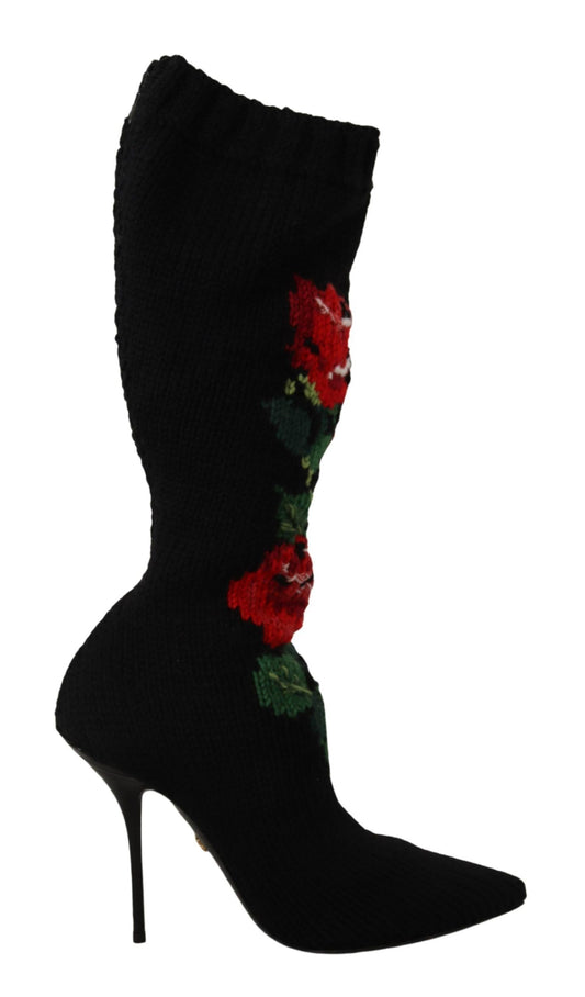 Black knit stretch sock bootie with pointed toe, stiletto heel, and embroidered red rose and green leaf design.