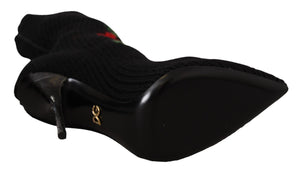 Black ribbed knit stretch sock bootie with red rose print, pointed toe, black stiletto heel, and gold DG logo accent.