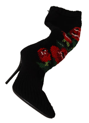 Black knit stretch sock stiletto bootie with a vibrant red rose floral pattern and ribbed texture.