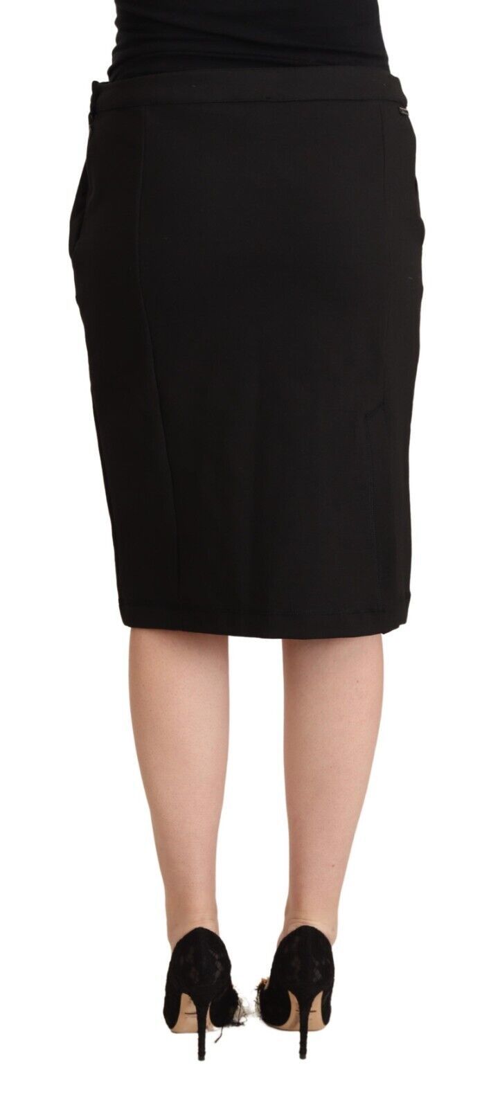 Black knee-length pencil skirt in a straight cut, worn with black heels
