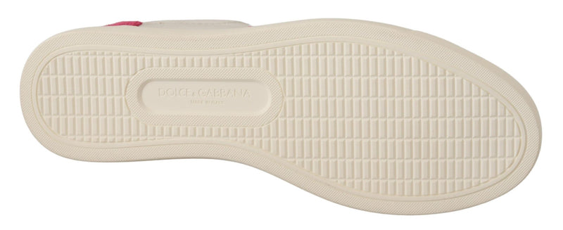 The cream-colored, rubberized tread sole of a Dolce & Gabbana women's low-top leather sneaker with pink heel detail.