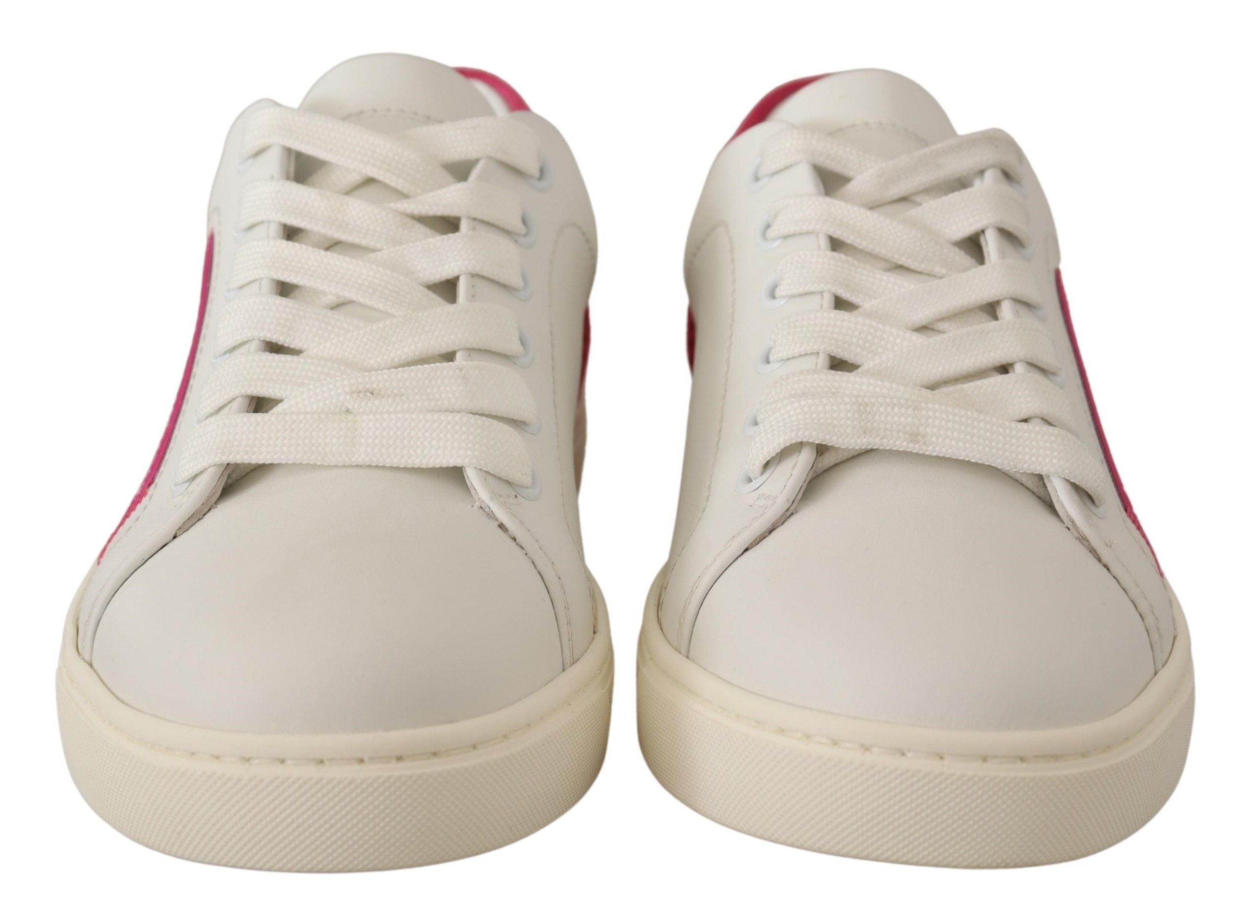 White leather low-top sneakers with lace-up closure and pink accents on the heel and sides.