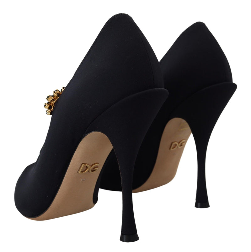 Black stretch fabric pumps with stiletto heels, featuring a crystal embellishment and gold DG logo on the sole.