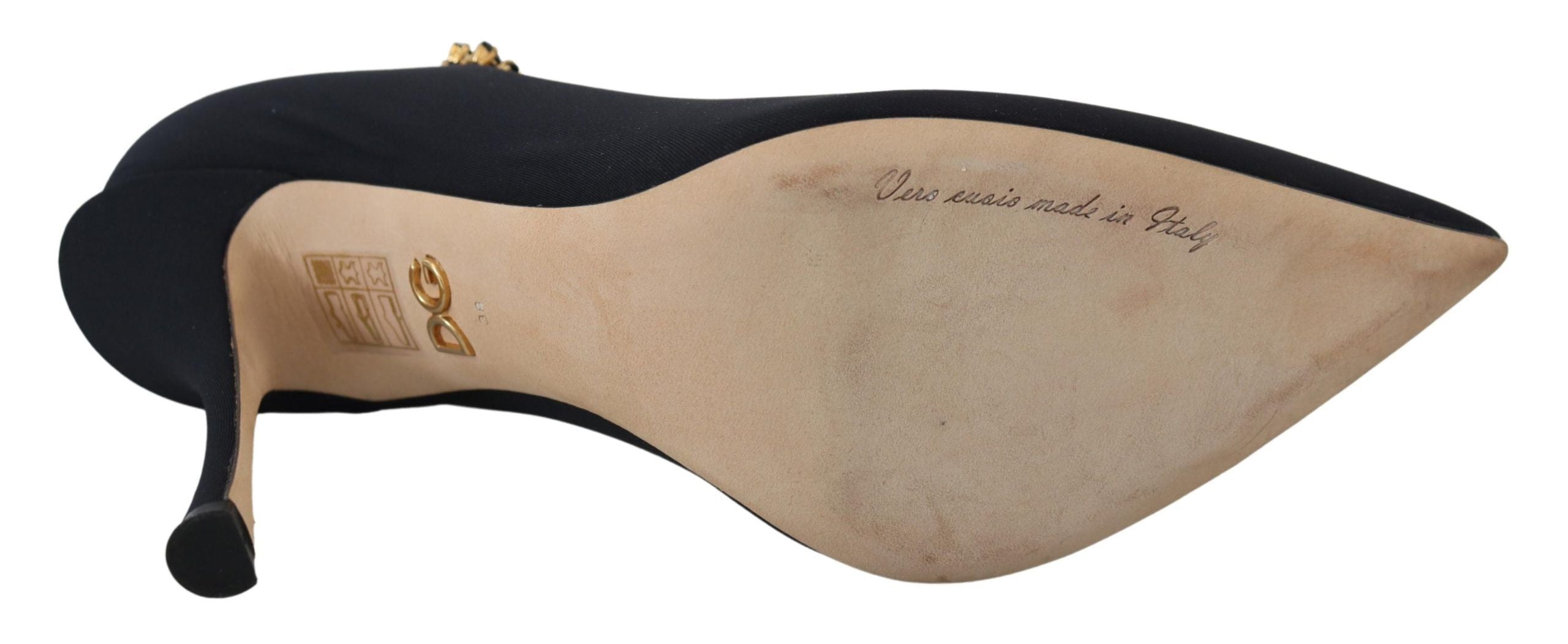 Dolce & Gabbana black stretch sock-style stiletto pump with gold crystal embellishment, showing beige leather sole.