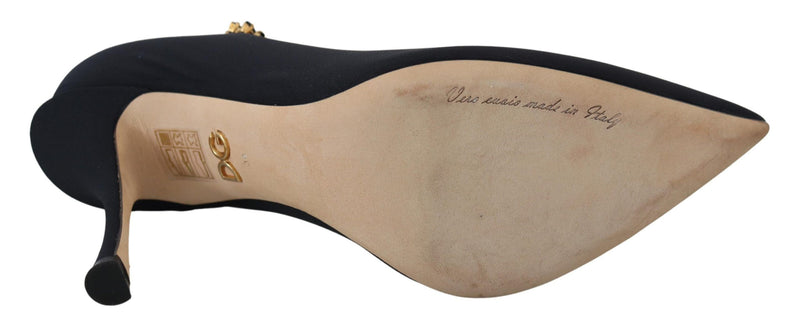 Dolce & Gabbana black stretch sock-style stiletto pump with gold crystal embellishment, showing beige leather sole.