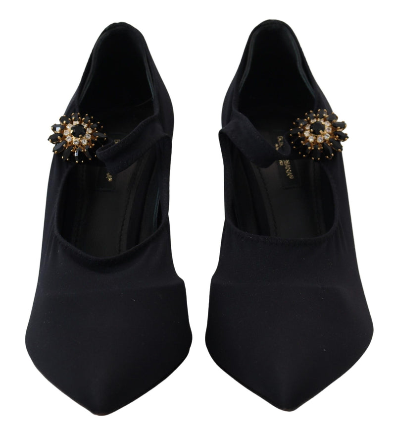 Black stretch fabric pumps with pointed toes, Mary Jane straps, and ornate black-and-clear crystal floral embellishments.