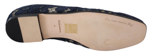 Dolce & Gabbana navy blue floral lace flat slip-on shoe with a tan leather sole and low heel.