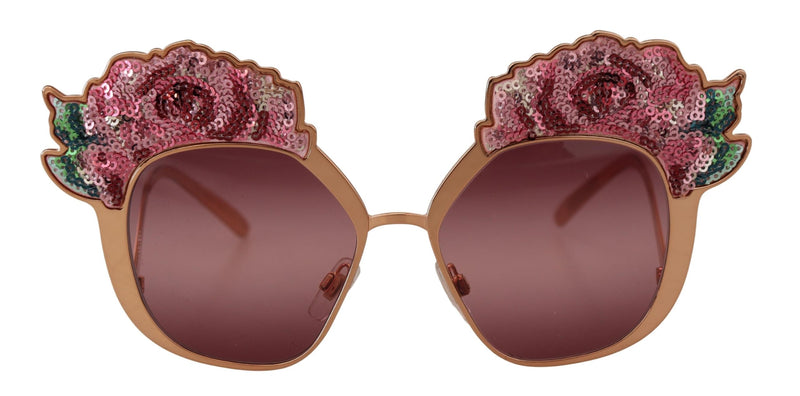 Rose gold sunglasses with pink tinted lenses and pink sequin rose embellishments along the top frames
