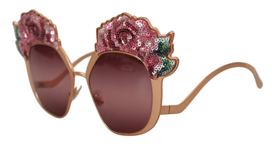 Rose gold sunglasses with pink tinted lenses and pink sequin rose embellishments along the top frames