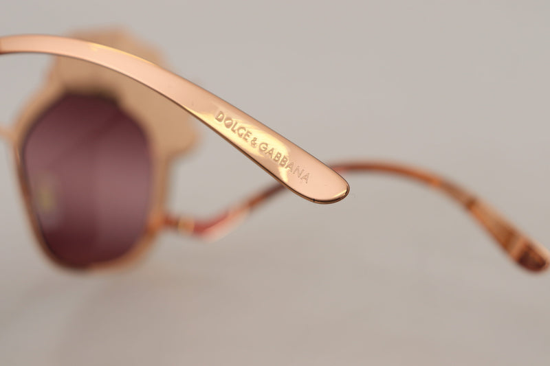 Close-up of pink gold metal sunglasses temple arm engraved with Dolce and Gabbana logo