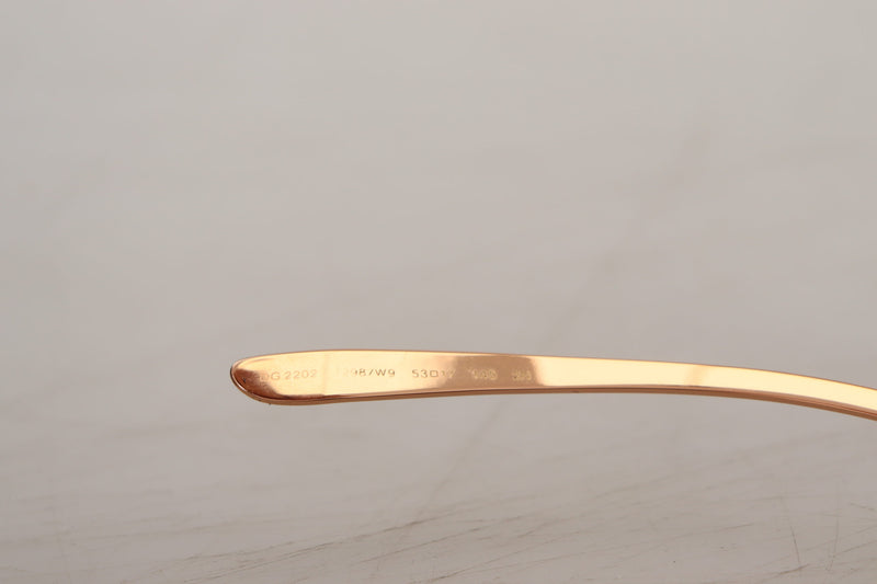 Close-up of pink gold metal sunglasses temple arm with product numbers engraved