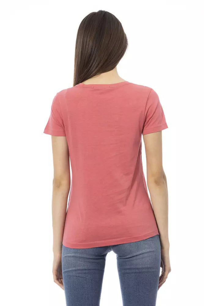 Back view of a woman wearing a pink cotton t-shirt and blue jeans