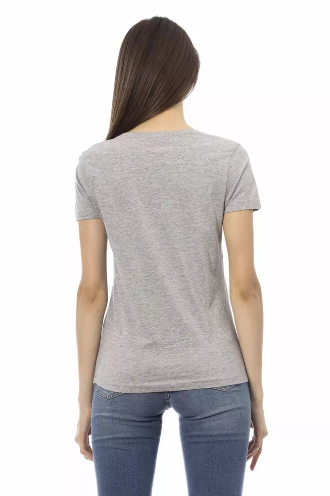 Back view of a woman wearing a gray cotton short-sleeve t-shirt and blue jeans