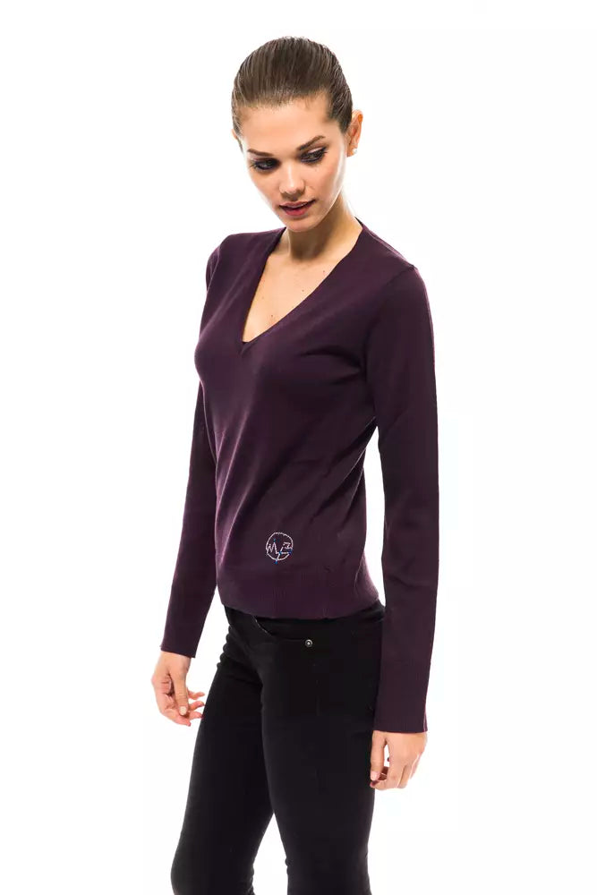 Woman wearing a dark purple V-neck knit wool sweater with long sleeves and a small logo near the hem