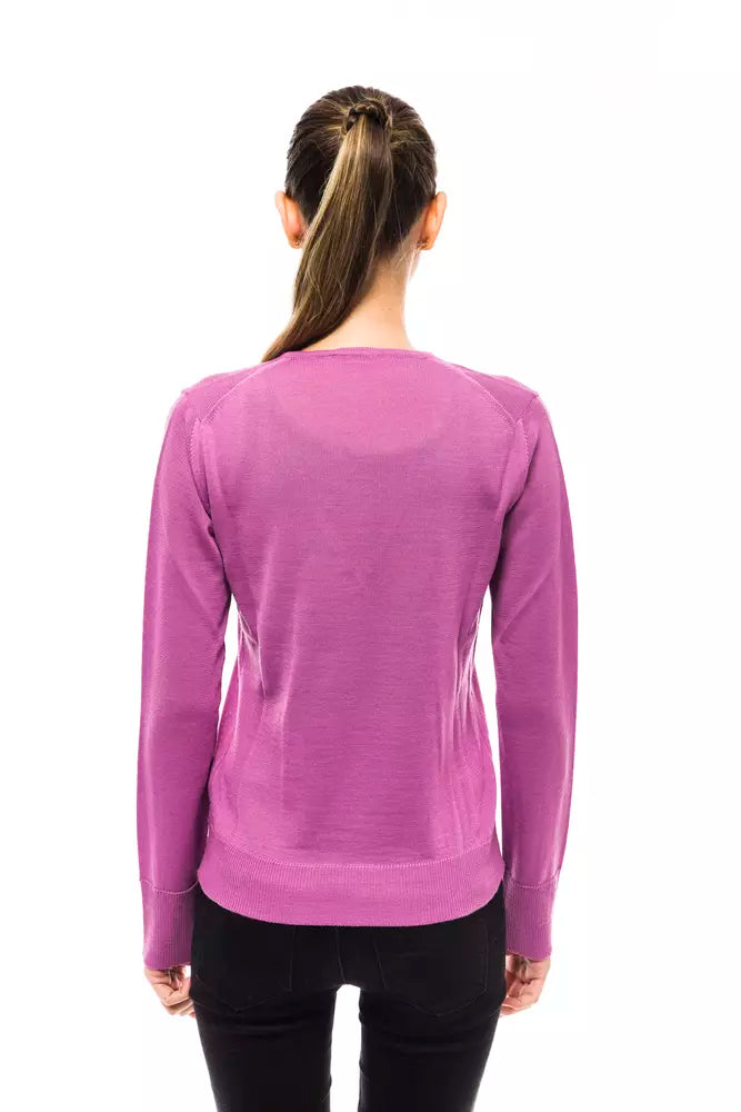 Back view of a woman wearing a long-sleeved purple wool sweater with ribbed cuffs and hem