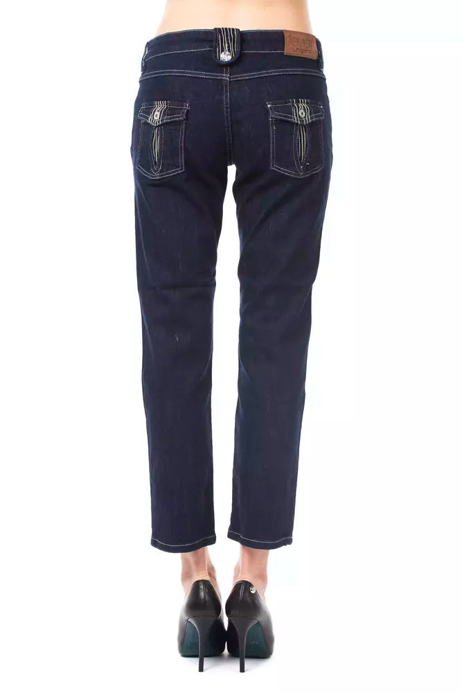 Dark blue cotton denim capri jeans with flap back pockets and high heels viewed from behind