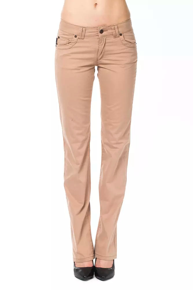 Beige cotton women's jeans in a slim fit style worn by a model