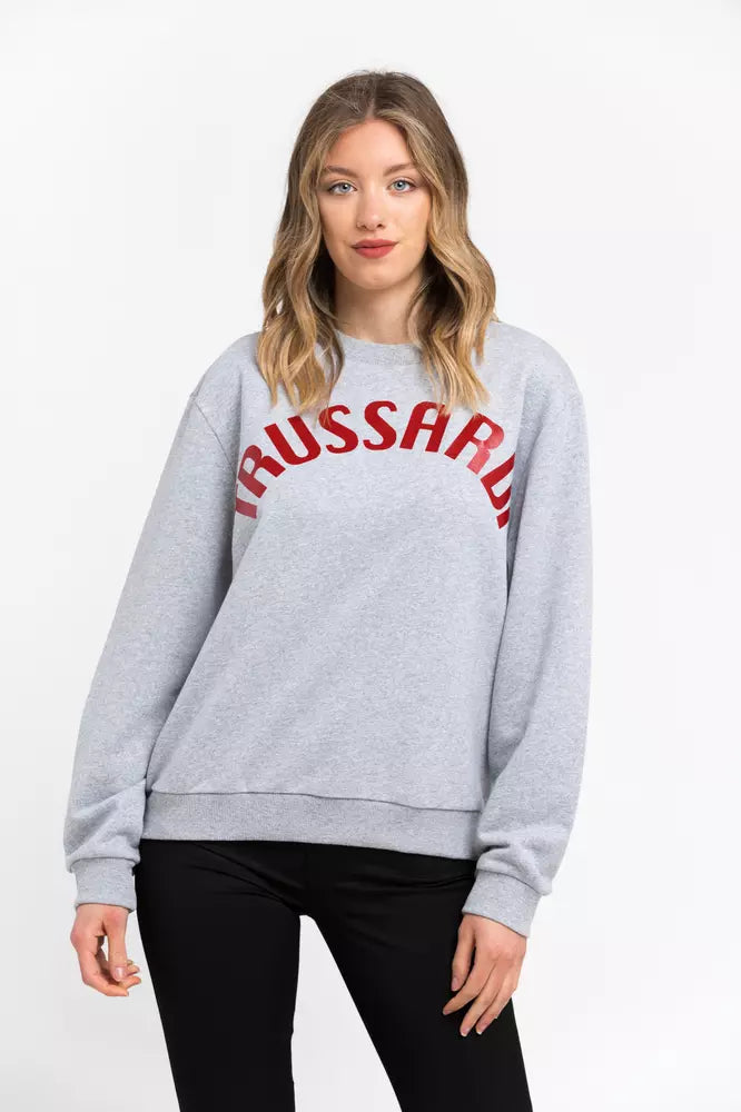 Woman wearing a gray cotton crewneck sweatshirt with red Trussardi lettering across the chest
