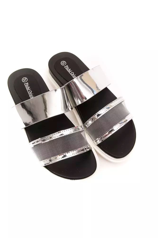 Péché Originel silver slide sandals with black footbeds, metallic straps, and grey mesh detail on a white sole.
