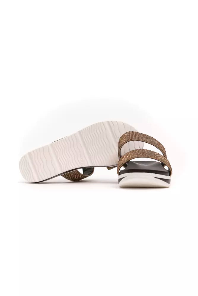 Péché Originel beige textile slide sandal with two shimmering straps and a thick, white wavy-textured platform sole.