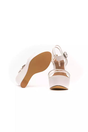 Péché Originel white polyethylene wedge sandals with ankle strap, clear toe strap, and buckle closure.