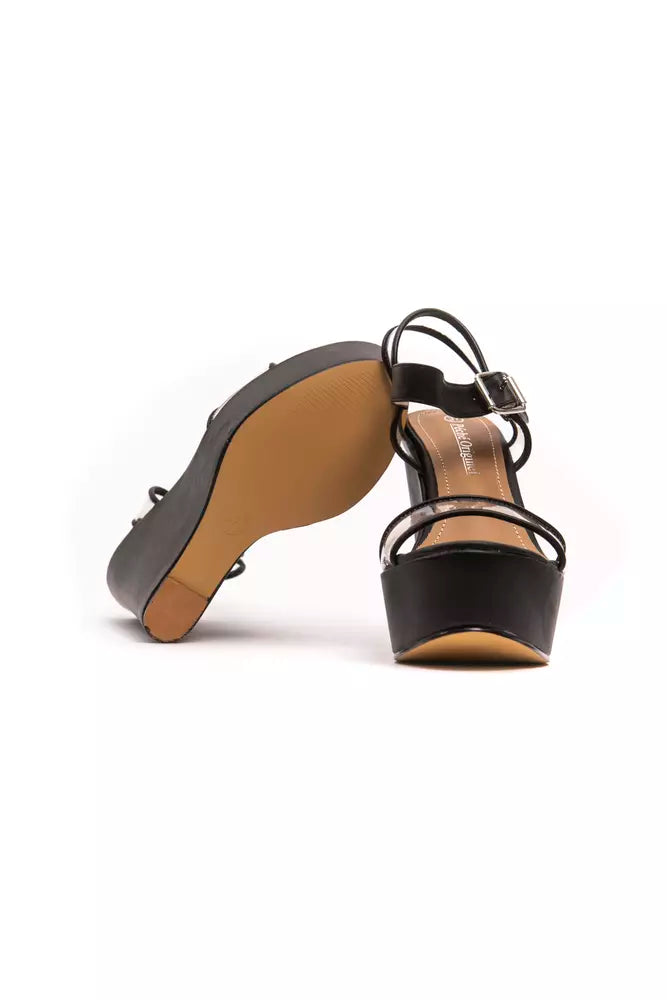 Péché Originel black polyethylene platform sandals with thin ankle straps, silver buckle, and tan soles.