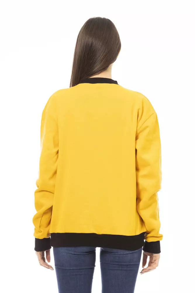 Woman wearing a yellow cotton sweatshirt with black collar and cuffs from behind