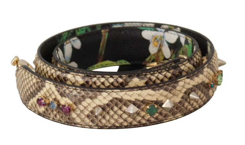 Coiled beige snakeskin shoulder strap adorned with colorful crystals and studs, with a floral pattern on the reverse side