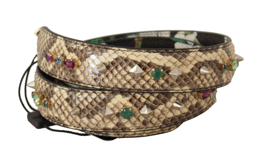 Coiled beige snakeskin shoulder strap adorned with colorful crystals and studs, with a floral pattern on the reverse side