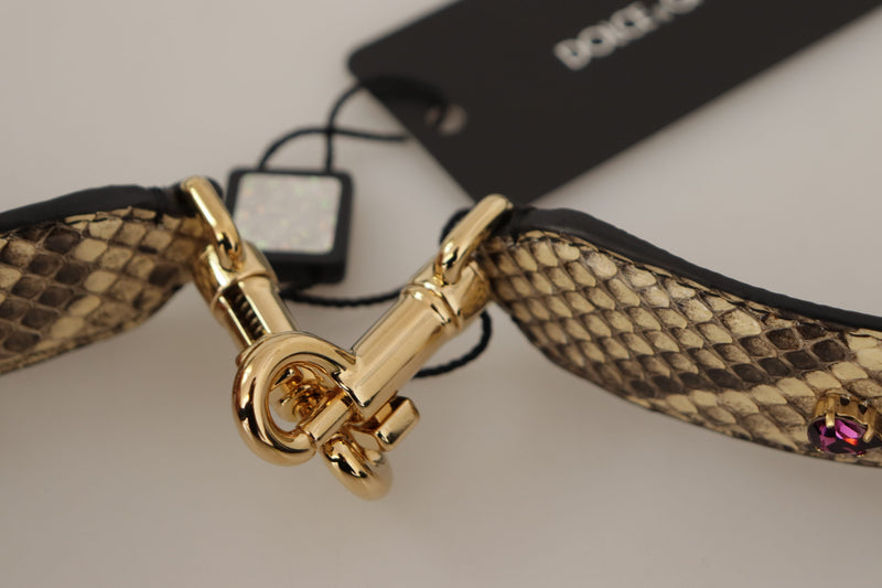 Beige snakeskin leather shoulder strap with gold hardware and a pink crystal accent