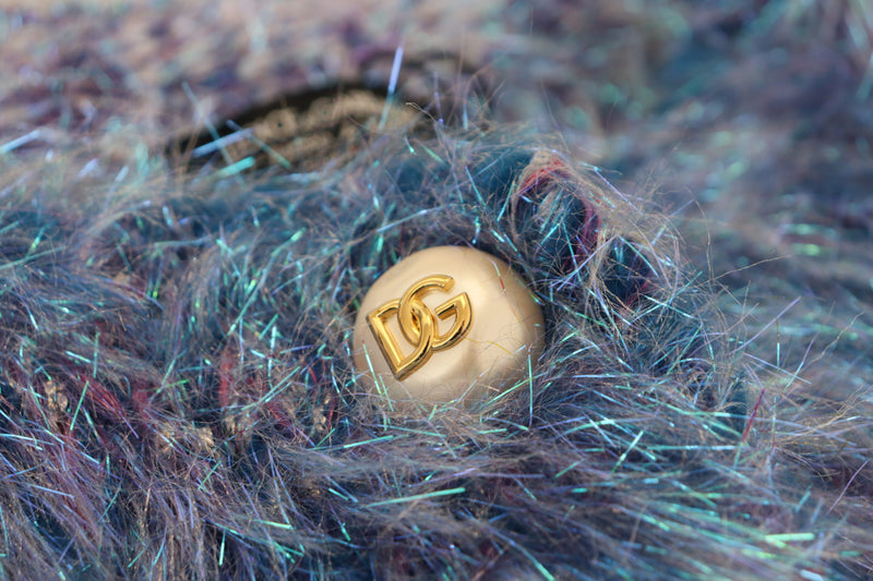Close-up of a multicolor polyester fringe jacket with a pearl-like button featuring a gold DG logo