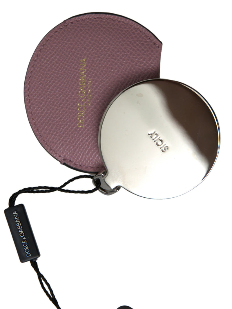 Pink textured leather round hand mirror holder with a silver metal mirror partially extended