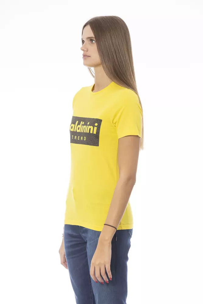 Bright yellow cotton women t-shirt with short sleeves and bold black logo print on the chest worn with blue jeans