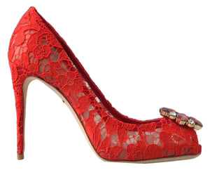 Red lace stiletto pump with a pointed toe, featuring an embellished crystal buckle on the front.