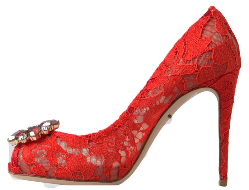Red lace stiletto pump featuring a pointed toe, a high heel, and a large, sparkling red crystal embellishment.