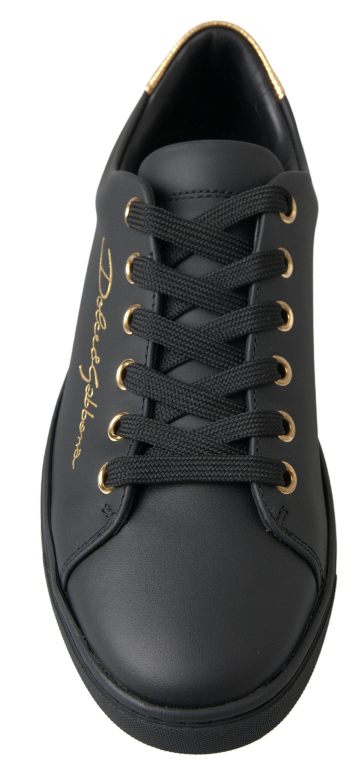 Black leather Dolce & Gabbana low-top sneaker with gold eyelets, gold logo embroidery, and a gold-trimmed heel collar.