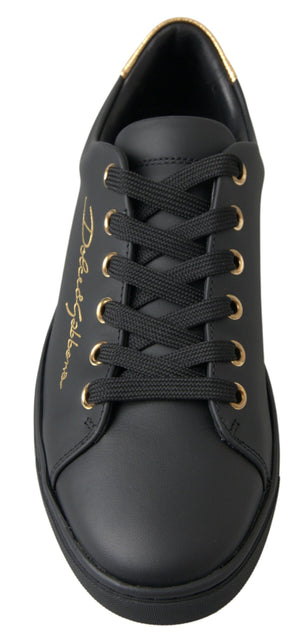 Black leather Dolce & Gabbana low-top sneaker with gold eyelets, gold logo embroidery, and a gold-trimmed heel collar.