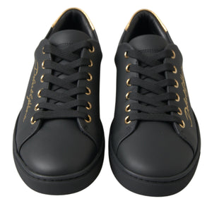 Black leather classic sneakers with gold eyelets, gold branding, and gold heel tab accents.