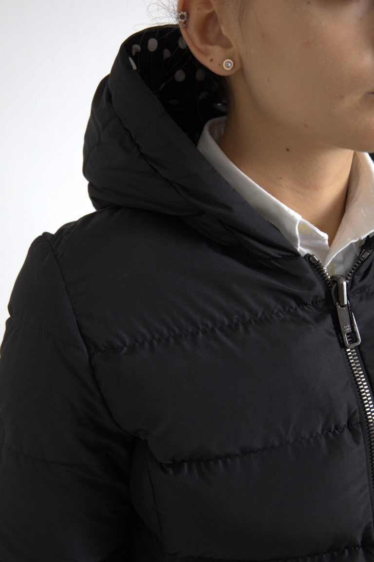 Black quilted polyester hooded jacket with visible zipper and white polka dot lining