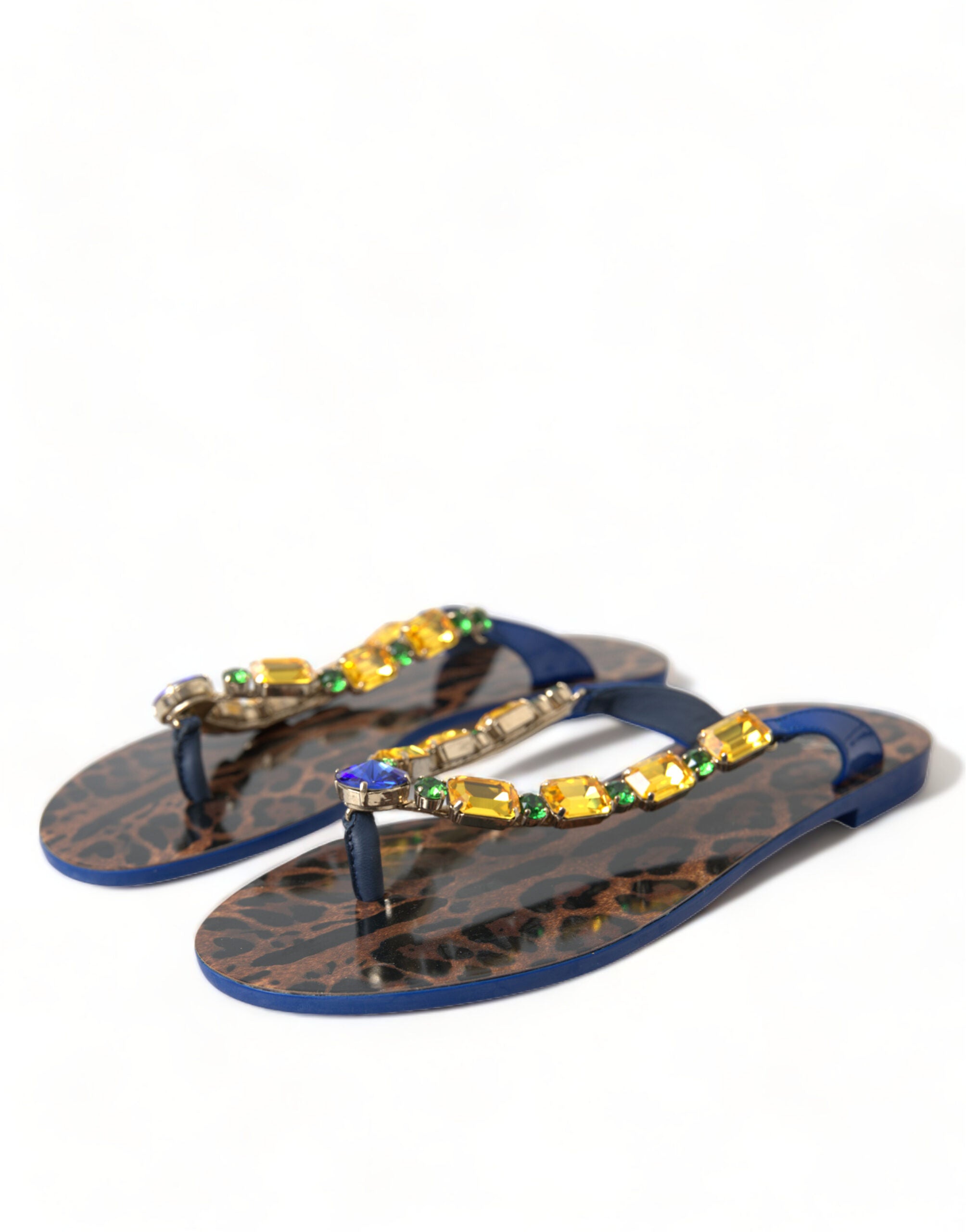 Dolce & Gabbana thong sandals featuring a leopard print footbed, blue trim, and colorful crystal-embellished straps.