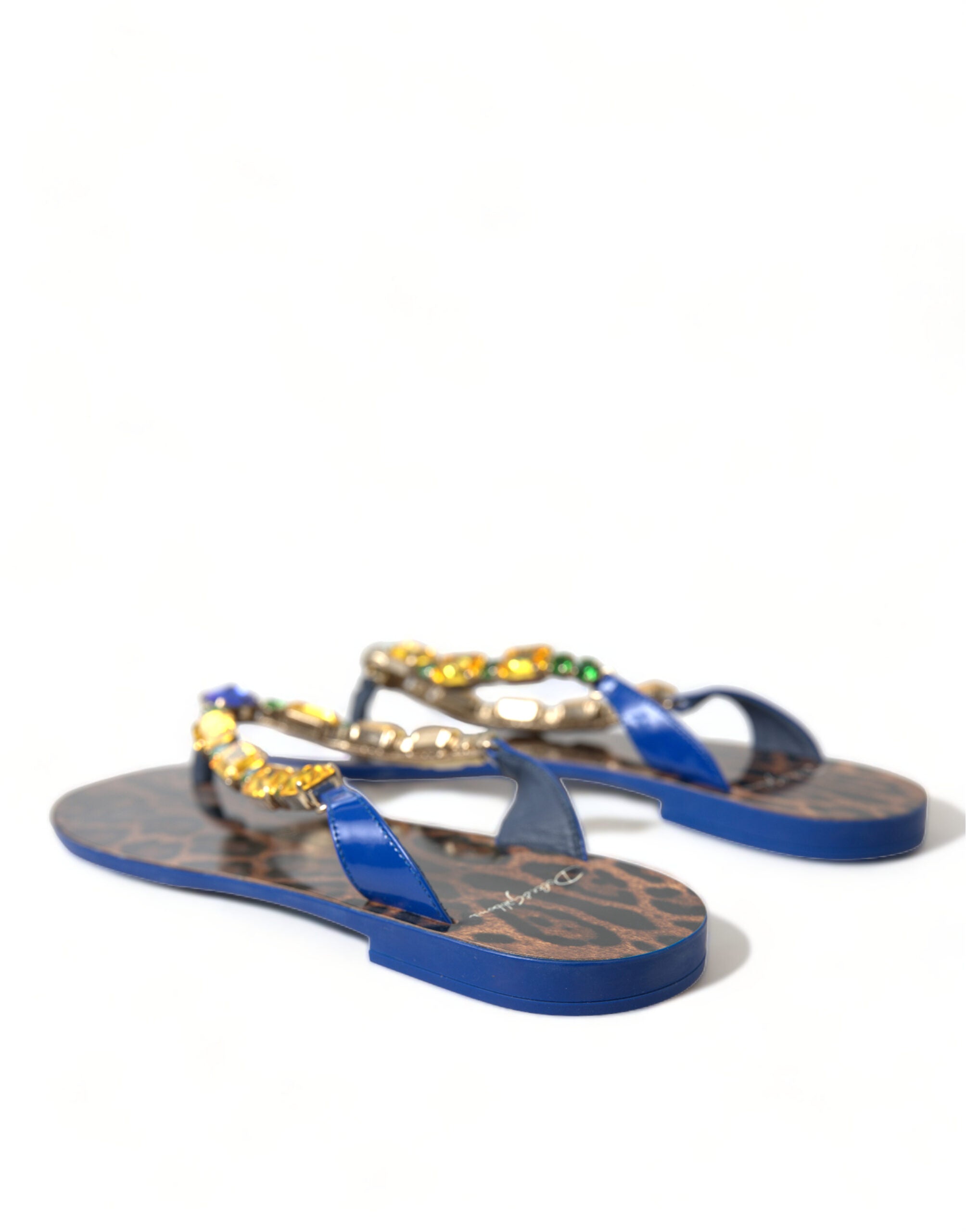 Blue patent thong sandals with leopard print insoles and multicolored crystal embellishments on the straps.
