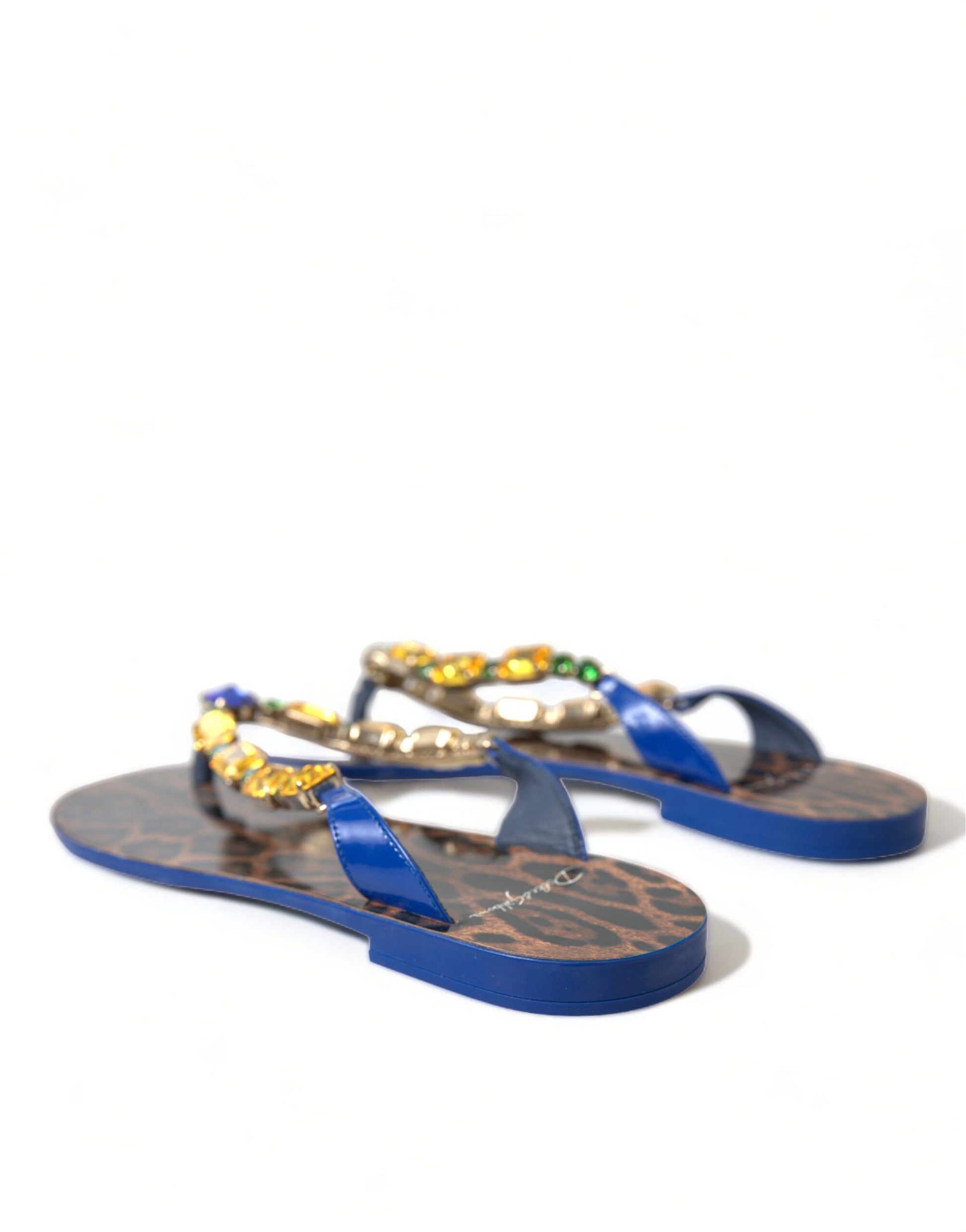 Blue patent thong sandals with leopard print insoles and multicolored crystal embellishments on the straps.