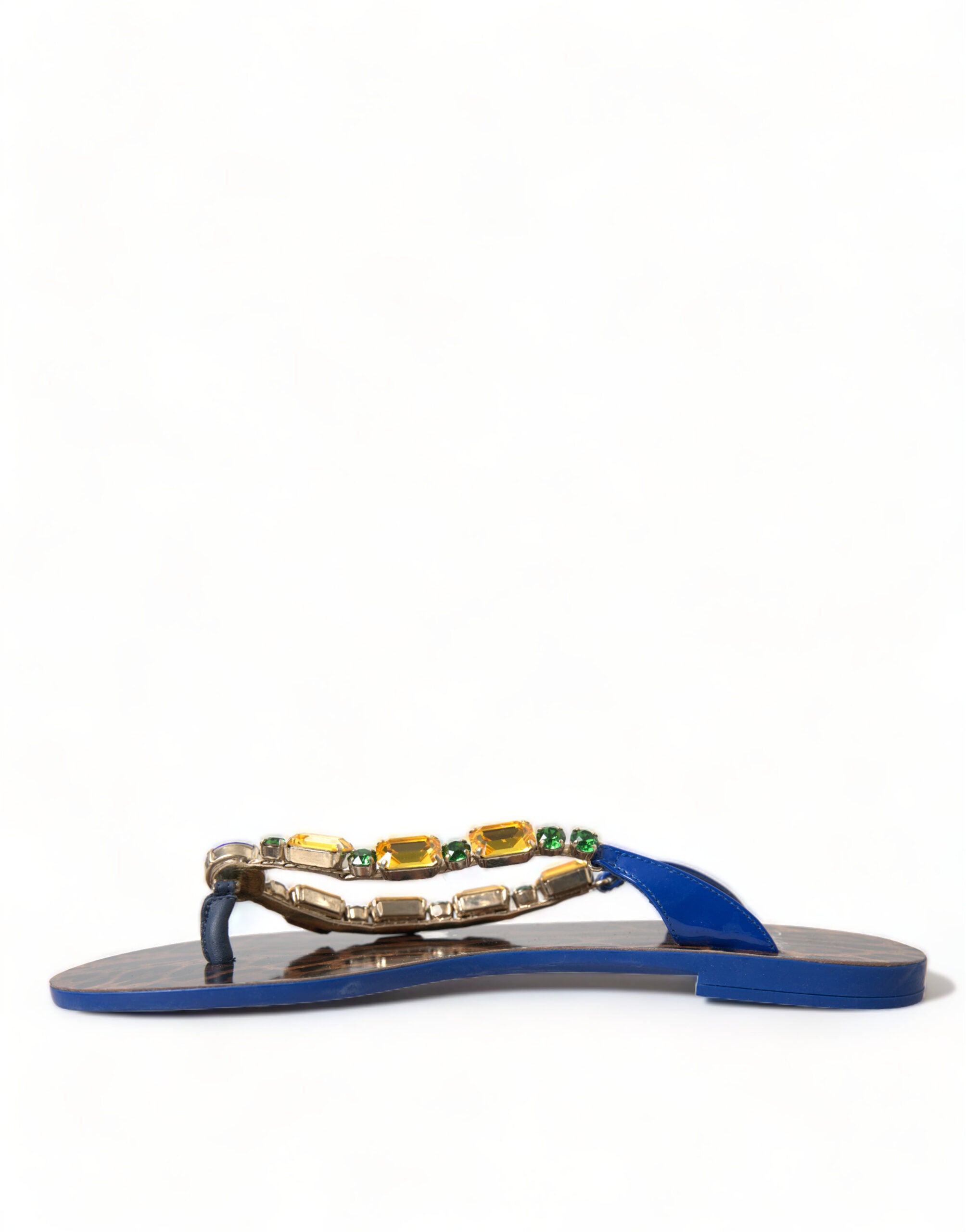Blue patent leather thong sandals with gold-tone accents, embellished with yellow and green crystals on the strap.